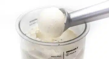 Kugel Vanilleeis ohne Zucker aus der Ninja Creami mit Portionierer über dem Becher